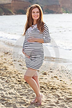 Pregnant woman is resting on beach