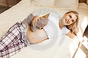 Pregnant woman resting in bed at home