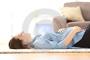 Pregnant woman resting on the floor at home