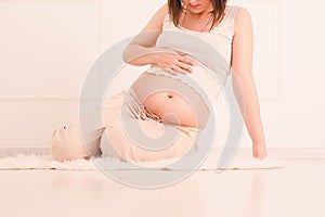 Pregnant woman resting at home, toned image