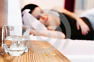 Pregnant woman resting with pills at hand