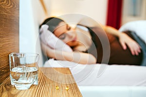 Pregnant woman resting with pills at hand