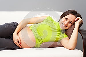 Pregnant woman resting on sofa