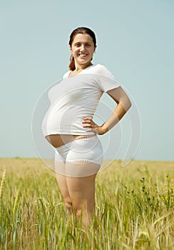 Pregnant woman in rye field