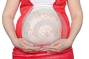 Pregnant woman`s belly with Christmas text