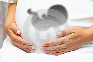 Pregnant woman`s belly closeup with  baby inside, conceptual motherhood image, 3D ultrasound concept