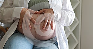 Pregnant woman's belly. Pregnant woman Close-up of women's hands made heart on the stomach. Healthy Pregnancy Maternity