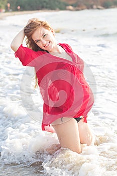 Pregnant woman on the sandy beach