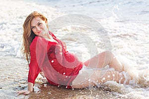 Pregnant woman on the sandy beach