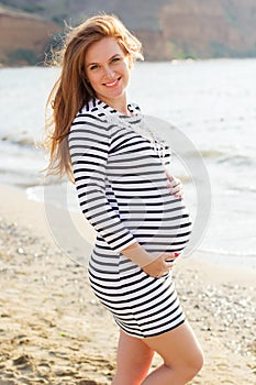 Pregnant woman on the sandy beach