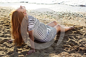 Pregnant woman on the sandy beach