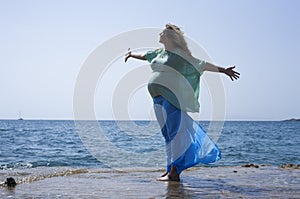 Pregnant woman by the sea