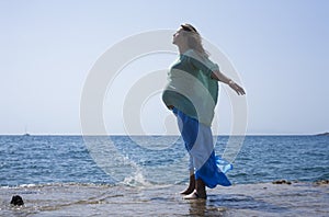 Pregnant woman by the sea