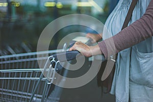 Pregnant woman with shopping trolley