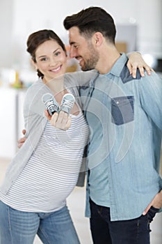 pregnant woman showing baby shoes