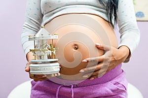 Pregnant woman showing belly to camera