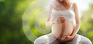 Pregnant woman sitiing in meditation pose, healthy pregnancy