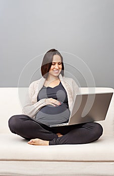 Pregnant woman sitting on sofa