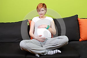 Pregnant woman sitting on sofa