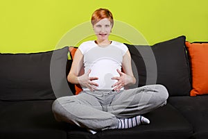 Pregnant woman sitting on sofa