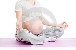Pregnant woman sitting in yoga lotus position