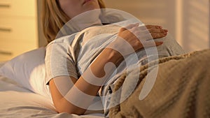 Pregnant woman sleeping on back in bed, inappropriate position, health care