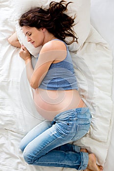Pregnant woman sleeping peacefully in the bedroom