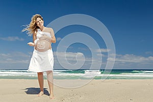 Pregnant woman with a smile on the belly