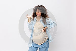 Pregnant woman smile maternity happiness finger pointing at her belly on a white  background in a t-shirt with a