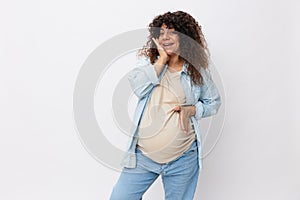 Pregnant woman smile maternity happiness finger pointing at her belly on a white isolated background in a t-shirt with a