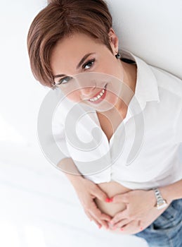 Pregnant Woman Smiles While Making Heart Sign On Her Tummy