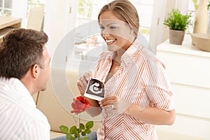 Pregnant woman smiling at man