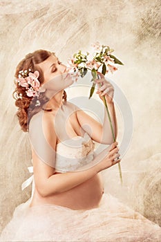 Pregnant woman sniffing flowers and dreaming.