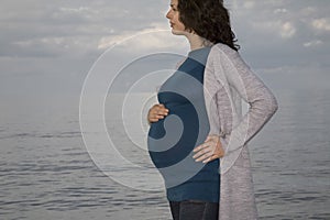 Pregnant Woman Standing Against Ocean