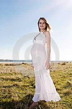Pregnant woman standing on field
