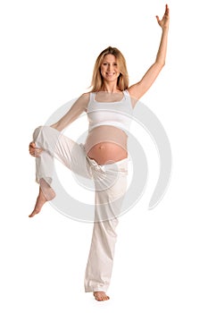 Pregnant woman standing and practicing yoga