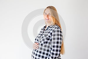 Pregnant woman standing on scales to control weight gain