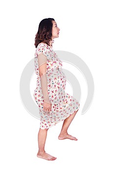 Pregnant woman stepping on imaginary step isolted on white