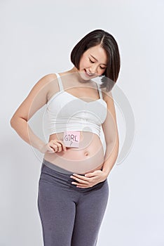 Pregnant woman with a sticky note saying Girl on her belly.  on white background