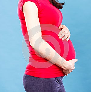 Pregnant woman with stomach pain touching her belly, concept of aches in pregnancy and risk of miscarriage