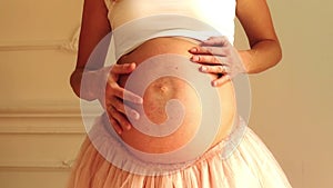 Pregnant woman stroking her belly