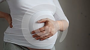 Pregnant woman stroking her belly