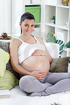Pregnant woman stroking in her belly