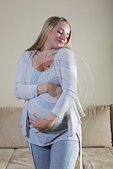 Pregnant woman stroking her belly