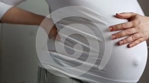 Pregnant woman stroking her belly