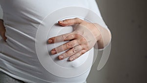 Pregnant woman stroking her belly