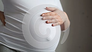 Pregnant woman stroking her belly