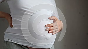 Pregnant woman stroking her belly