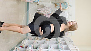 Pregnant woman stroking her belly at the supermarket