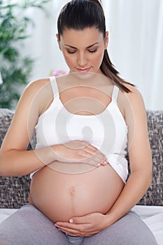 Pregnant woman stroking her tummy